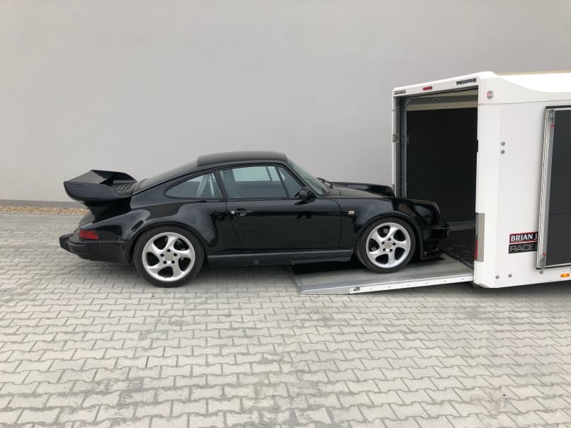 Luxury car transports in a closed trailer